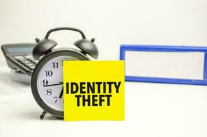 Retro alarm clock and the text IDENTITY THEFT word photo