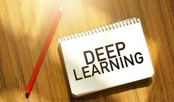 DEEP LEARNING of the box on notebook on wooden background photo