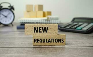 new regulations is shown on a conceptual photo using wooden blocks