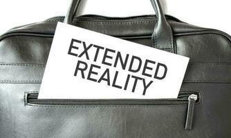 Text EXTENDED REALITY writing on white paper sheet in the black business bag. Business concept photo