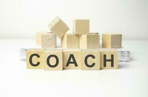 coach Word In Wooden Cube on white background photo