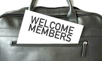 Text WELCOME MEMBERS writing on white paper sheet in the black business bag. Business concept photo