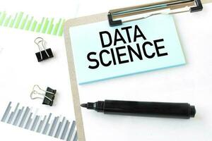 Paper plate, marker, diagram, chart and office tools. Text DATA SCIENCE photo