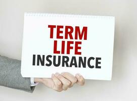 Businessman holding a card with text TERM LIFE INSURANCE photo