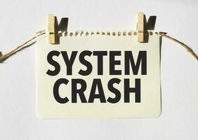 Card with text SYSTEM CRASH . Diagram and white background photo