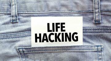 Text LIFE HACKING on a white paper stuck out from jeans pocket. Business concept photo