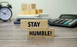 stay humble is shown on a conceptual photo using wooden blocks