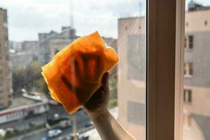 hand wipes dirty outdoor side of window at home photo