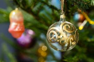 glass baubles on natural christmas tree close up photo