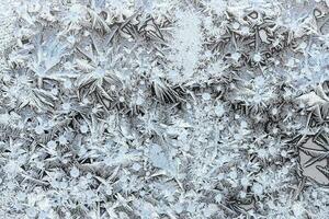 frost pattern on surface on home window close up photo