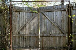 old wooden gate made of planks in village yard photo