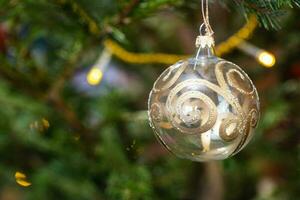 ball decorated with gold pattern on xmas tree photo