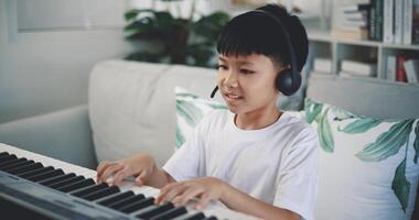 Cute boy enjoy to learning playing piano at home photo