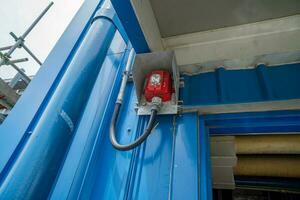 Fire alarm horn on the near door of pump house. The photo is suitable to use for industry background photography, power plant poster and electricity content media.