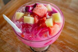 Mixing ice fruit on the medium glass with red sugar. The photo is suitable to use for drink background, menu poster and content media.