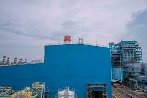 Arial view of power plant project with blue sky and cloudy vibes. The photo is suitable to use for industry background photography, power plant poster and electricity content media.