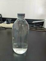 Clear water on the bottle transparent for laboratory usage. The photo is suitable to use for laboratory background and content media.