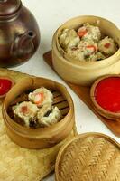 Delicious Dim Sum in bamboo steamer on the Table, Tasty Chinese Food. selective focus. photo