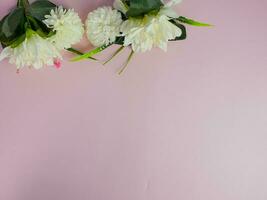 white flower composition on pink pastel background with copy space for text photo