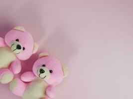 Lovely pink bear doll on pink background. adorable pink bear for decorative. with copy space for text photo