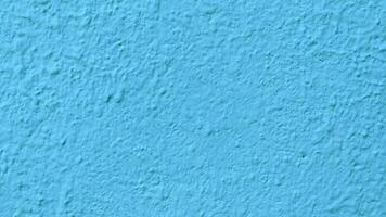 Blue stucco texture of a wall with copy space for background photo