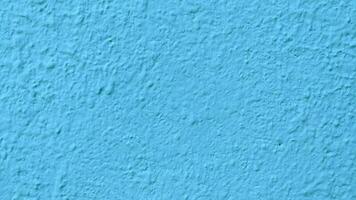 Blue stucco texture of a wall with copy space for background photo