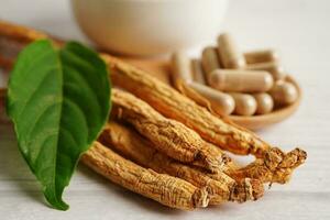 Ginseng roots and green leaf, healthy food. photo
