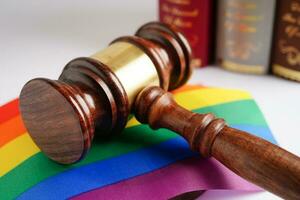 Gavel for judge lawyer with heart rainbow flag, symbol of LGBT pride month. photo