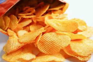 Potato chips in open bag, delicious BBQ seasoning spicy for crips, thin slice deep fried snack fast food. photo