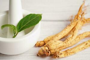 Ginseng roots and green leaf, healthy food. photo