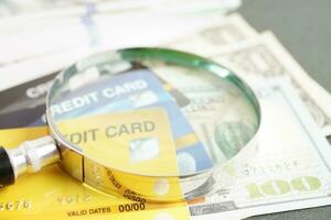 Credit card and magnifying glass for online shopping, security finance business concept. photo