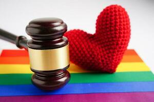 Gavel for judge lawyer with heart rainbow flag, symbol of LGBT pride month. photo