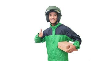 Portrait of Asian online courier driver wearing green jacket and helmet delivering package and box for customer. Isolated image on white background photo