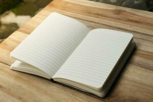 Close up of empty note book on wooden table during the day photo