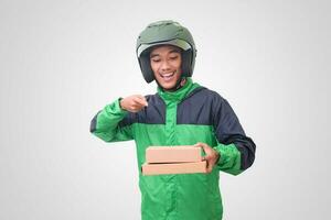 Portrait of Asian online courier driver wearing green jacket and helmet delivering package and box for customer. Isolated image on white background photo