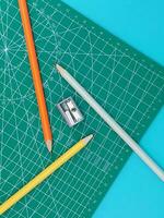 Green Cutting mats , Pen drawings , adjust angle tool , scale ruler on blue background photo