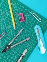 Green Cutting mats , Pen drawings , adjust angle tool , scale ruler on blue background photo