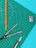 Green Cutting mats , Pen drawings , adjust angle tool , scale ruler on blue background photo