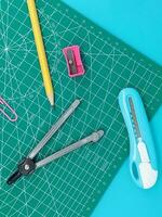 Green Cutting mats , Pen drawings , adjust angle tool , scale ruler on blue background photo