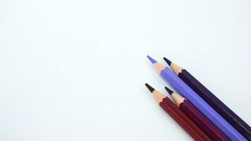 Purple pencils on a purple divided background in a close up view photo