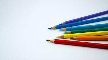 Many different colored pencils on white background photo