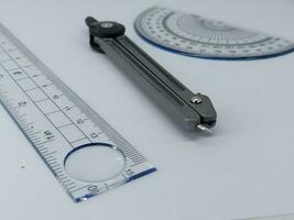 drawing compass and ruler on table photo