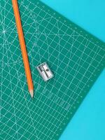 Green Cutting mats , Pen drawings , adjust angle tool , scale ruler on blue background photo