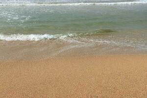 Beautiful waves on the sand beach background. photo