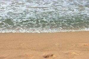 Soothing waves crashing on beach photo