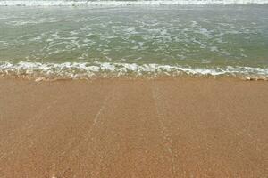 Beautiful waves on the sand beach background. photo