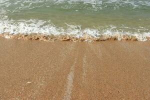 Beautiful waves on the sand beach background. photo