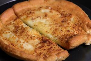 Delicious garlic pizza slices with tasty cheese falling from photo