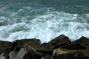 Fantastic Rocky coast. Sea waves impact rocky on the beach photo