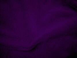 Purple clean wool fabric texture background. light natural sheep wool. Violet seamless cotton. texture of fluffy fur for designers. close-up fragment wool carpet. photo